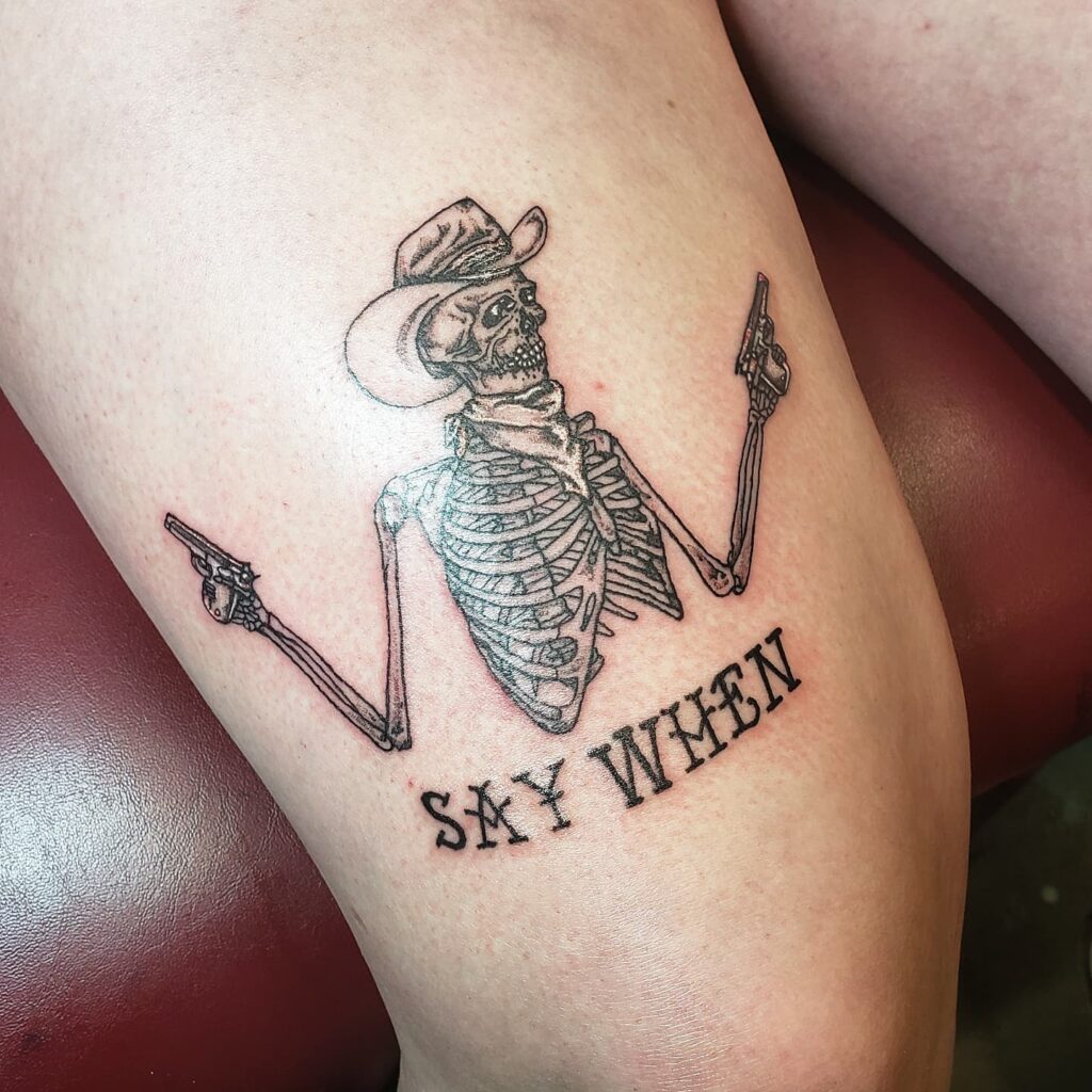 Unleash Your Inner Cowboy Cowboy Skeleton with Say When Text Tattoo Ideas Above Knee