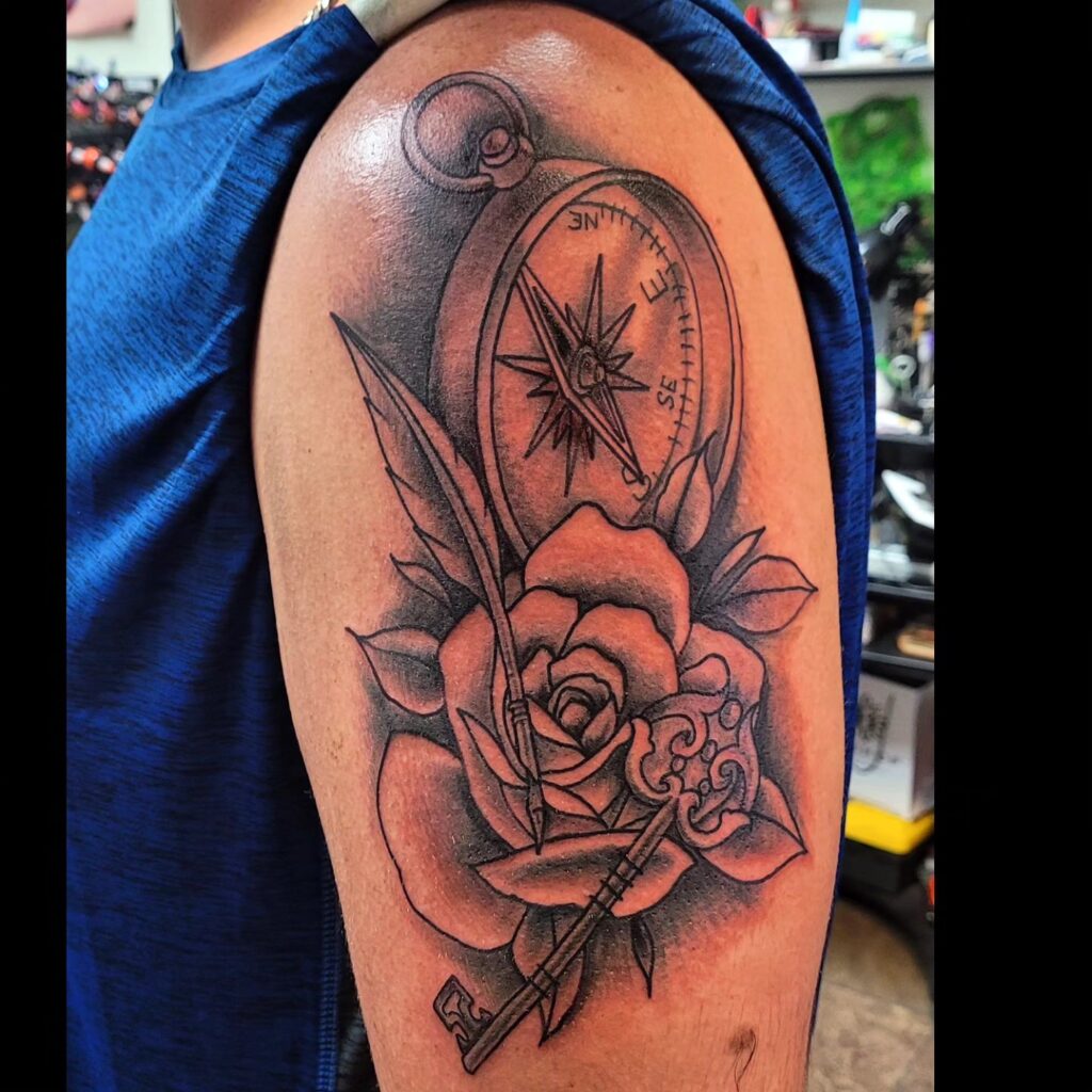 Unlocking secrets compass rose and key upper arm tattoo