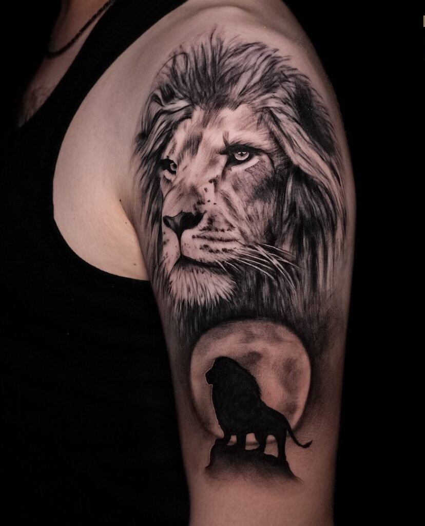 Upper arm black shaded lion tattoo with big lion side view face and another lion king in the full moon: moonlit pride