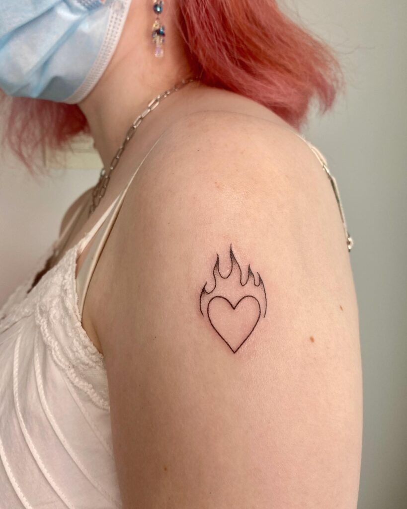 Upper arm outline heart and flame tattoo for women a passionate design