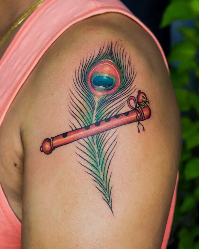 Upper arm showpiece eye-catching peacock feather tattoo with flute