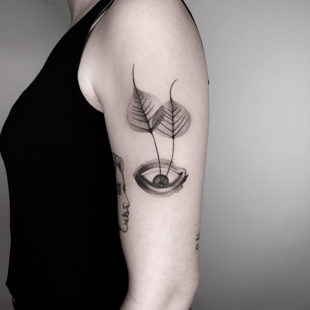 Upside Down Eye Tattoo Design on Hand With Two Leaves