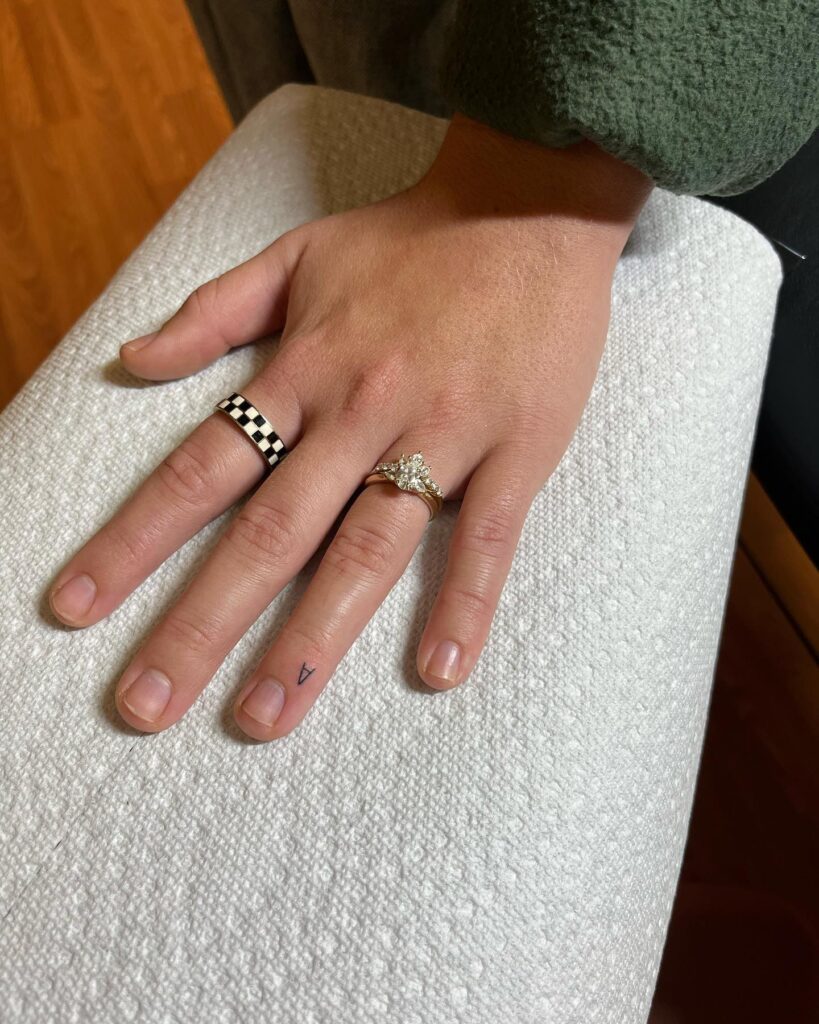 Very Small A Tattoo Near the Nail of the Ring Finger Exhibiting Subdued Sophistication Minimal A