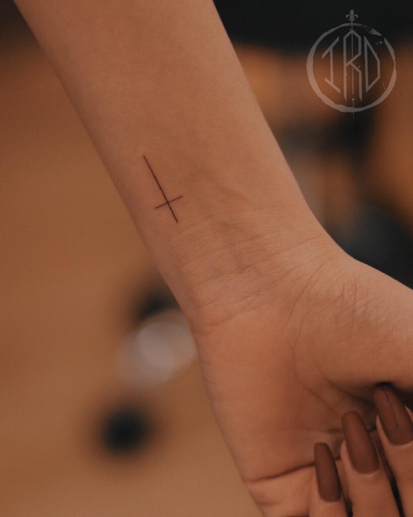 Very Thin Cross Tattoo on the Side of the Inner Wrist, a Delicate Emblem of Faith: Graceful Faith