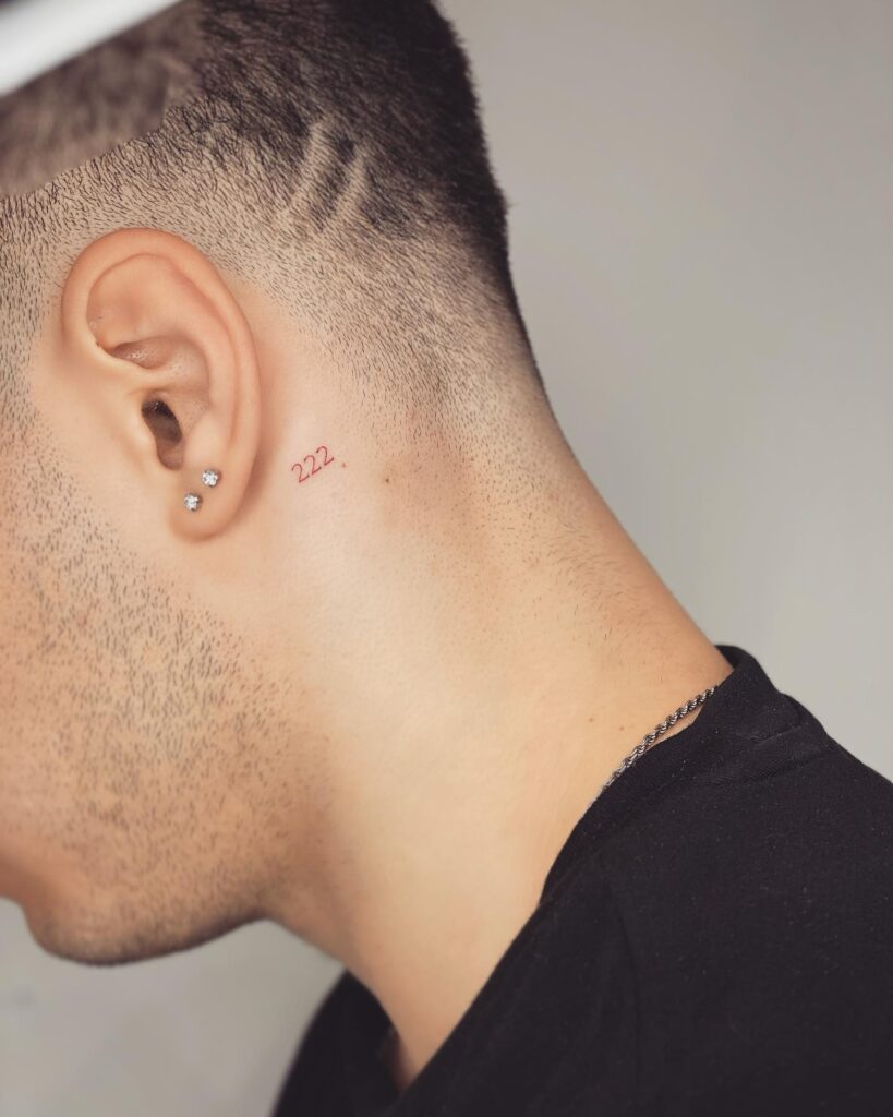 Very Small 222 Tattoo on the Behind the Ear in Red Color for Men, a Hidden Symbol: Understated Charm 