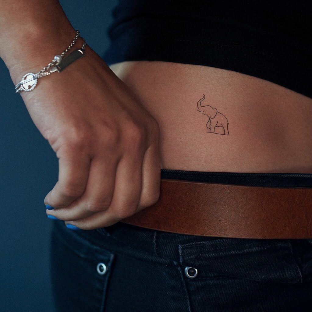 Very small minimal fineline elephant tattoo, a beautiful and clean side view outline delicate waistline majesty