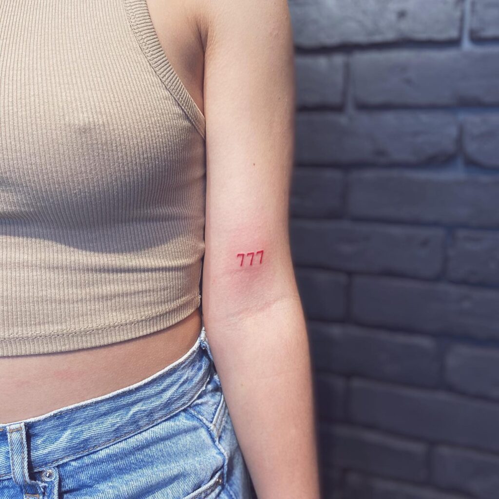 Vibrant 777 Angel Number Above the Elbow Tattoo: Red Radiance 