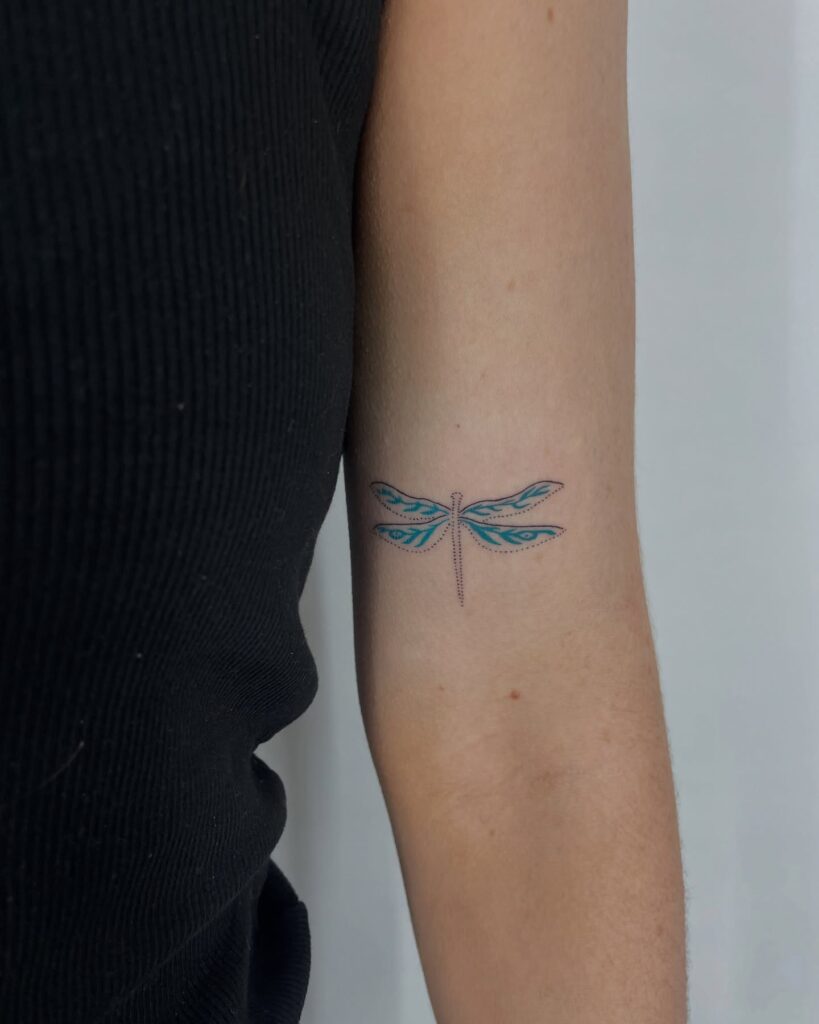 Vibrant Blue Accents and Dotwork Dragonfly Tattoo on Arm
