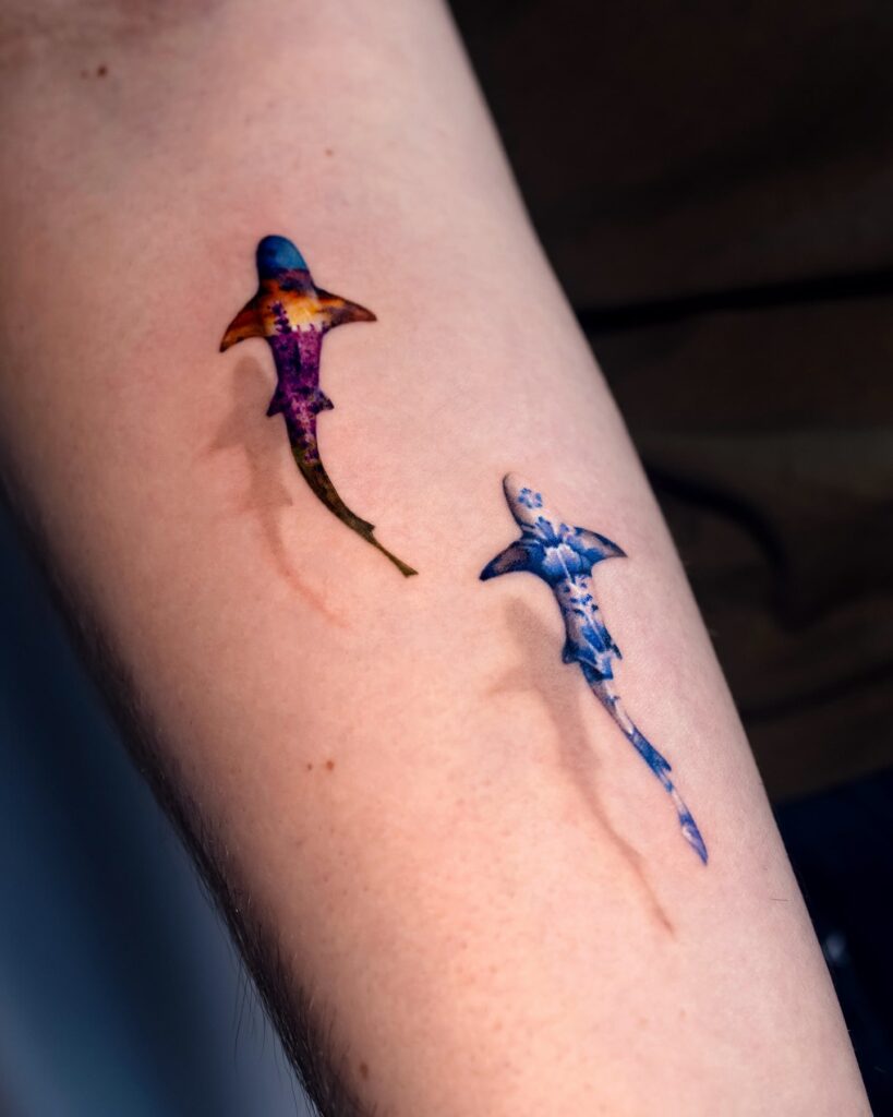 Vibrant hammerhead shark tattoo with sunset and ocean color gradients for a unique artistic effect