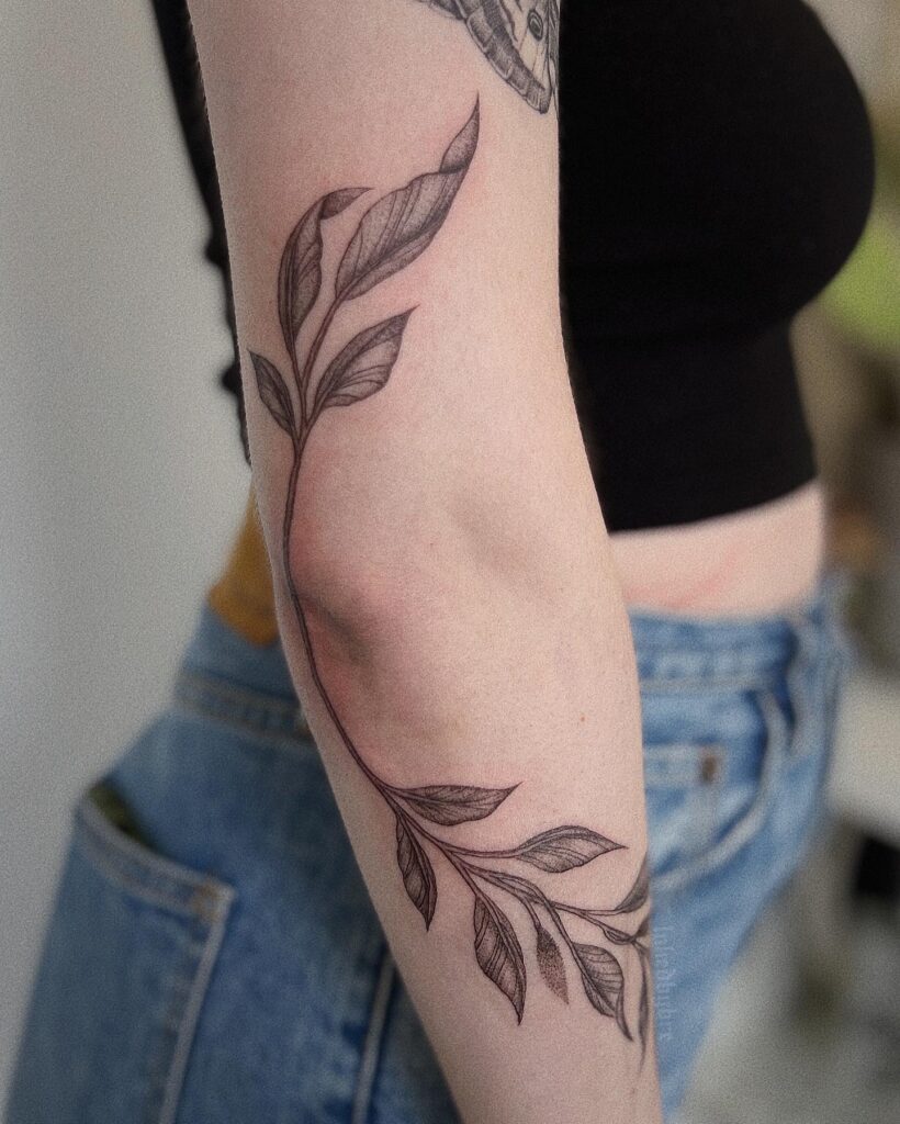 Vine Tattoo Wrapping Around the Elbow Symbol of Growth