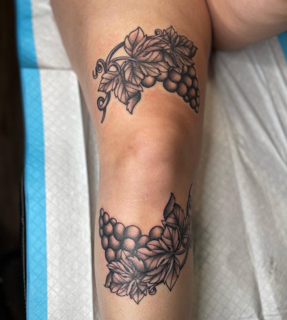 Vine ink tattoo above knee image