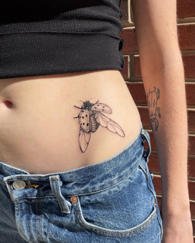 Vintage flair side stomach neo-traditional ladybug tattoo for females