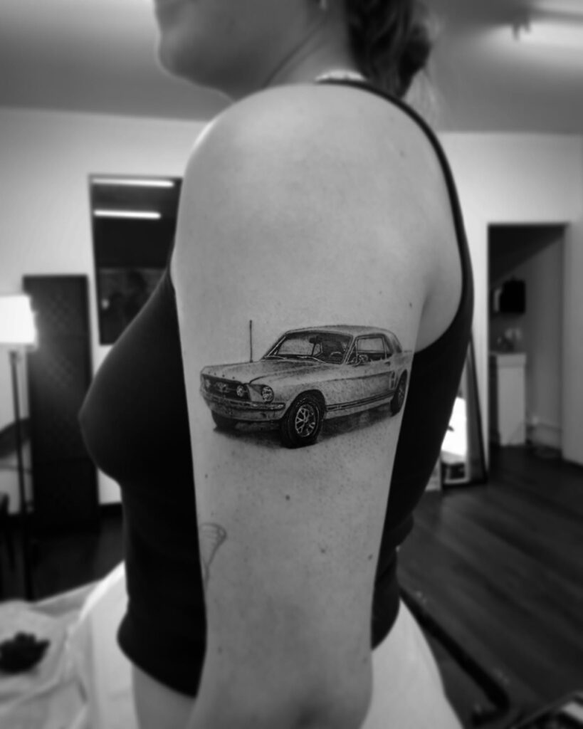Vintage Ford Mustang Tattoo with Intricate Linework on Outer Arm for Women – Car Tattoo Ideas