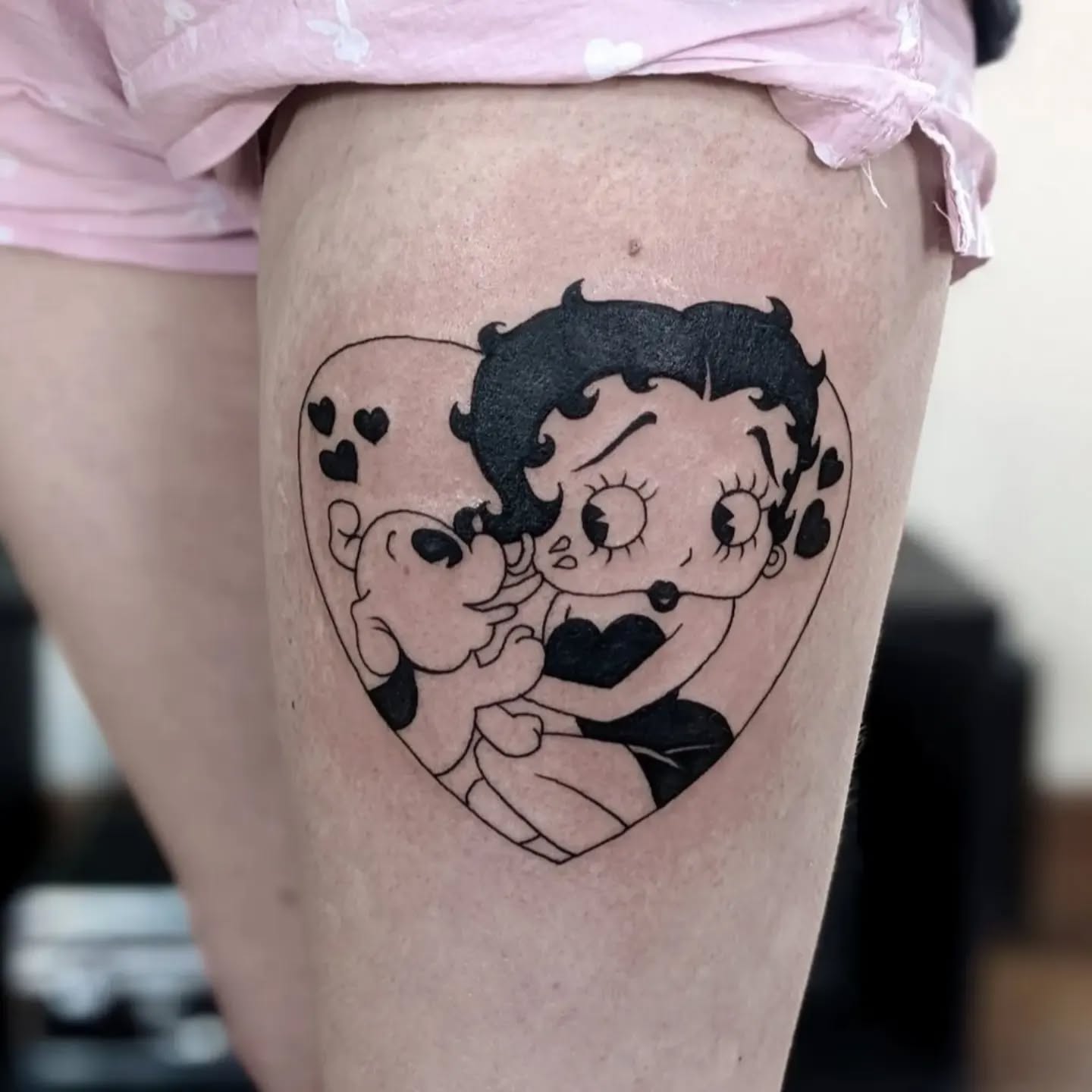 Vintage-inspired Betty Boop tattoo featuring her and Pudgy inside a heart with floating hearts, perfect for fans of classic animation and retro aesthetics