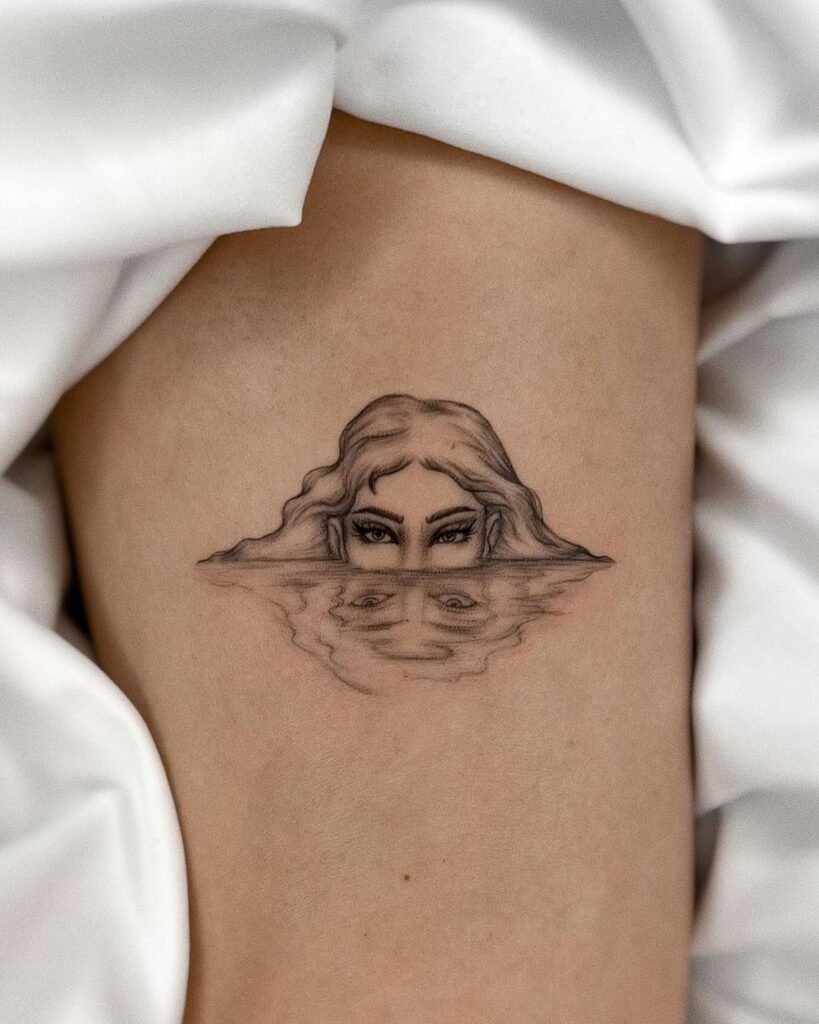 Water reflection girl half face tattoo on the inner arm arm artistry