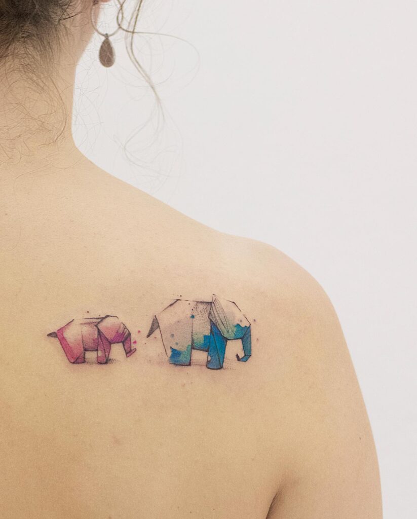 Watercolor artistry behind the shoulder: whimsical origami elephants