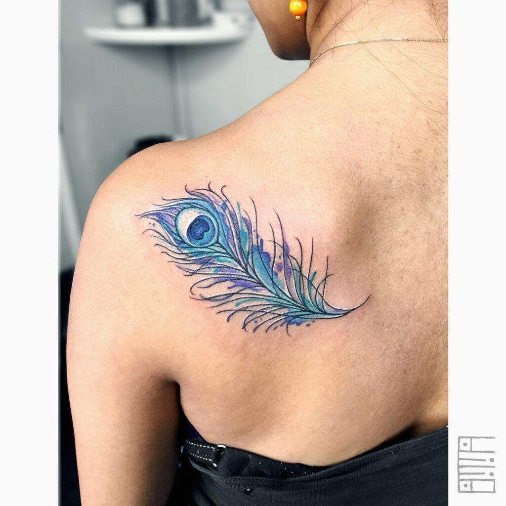 Watercolor dreams artistic watercolor peacock feather tattoo behind the shoulder for women