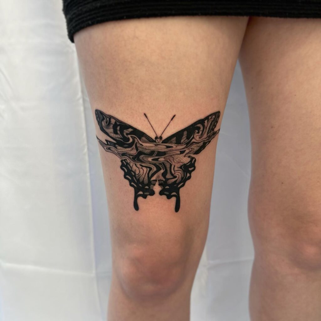 Wavey butterfly a fluttering elegance on your thigh