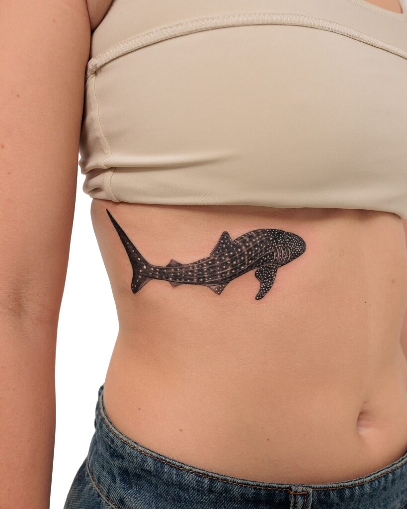 Whale shark ribcage tattoo with fine dot work and shading for an elegant ocean-inspired design