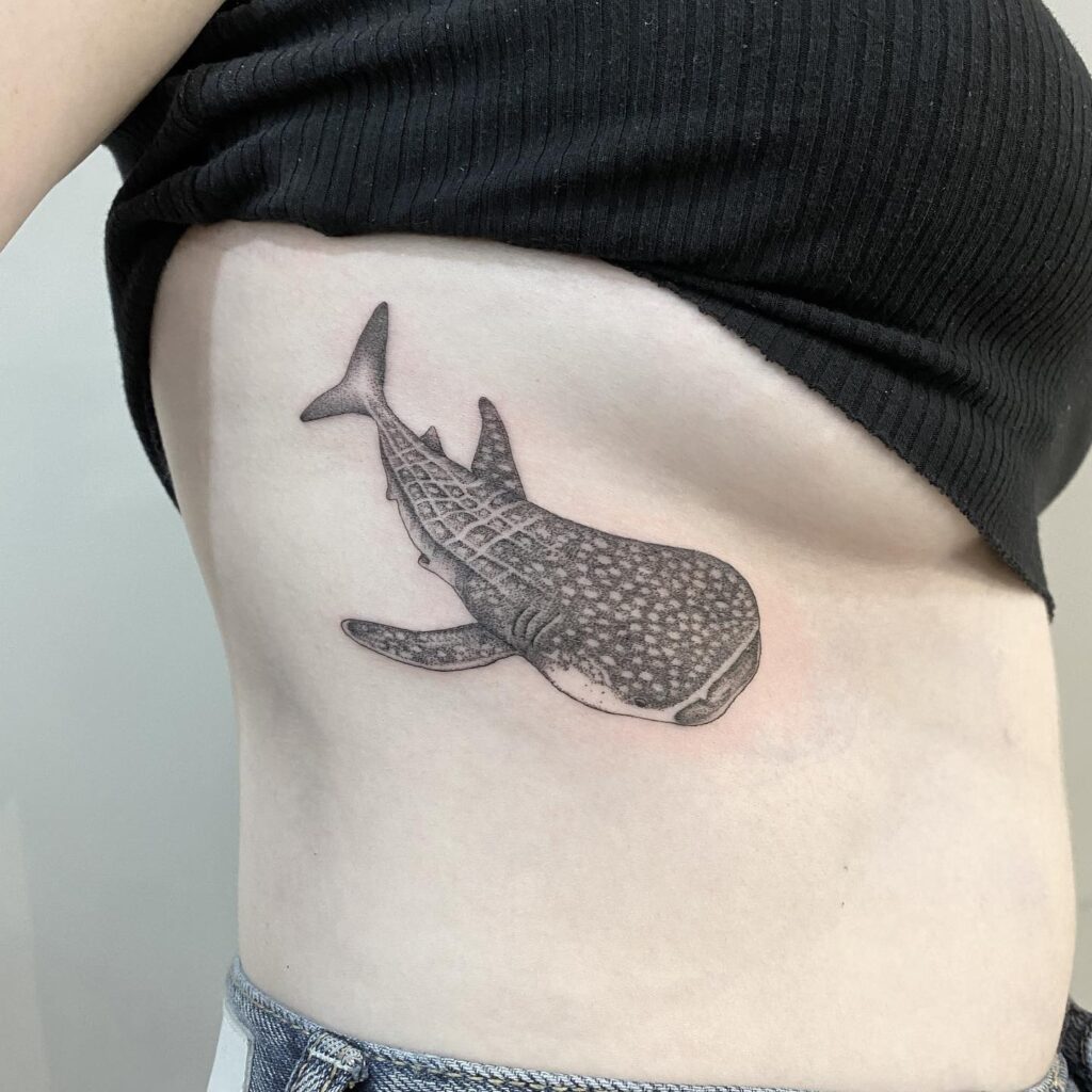 Whale shark tattoo, detailed rib ink in black and grey for a top view masterpiece: oceanic majesty