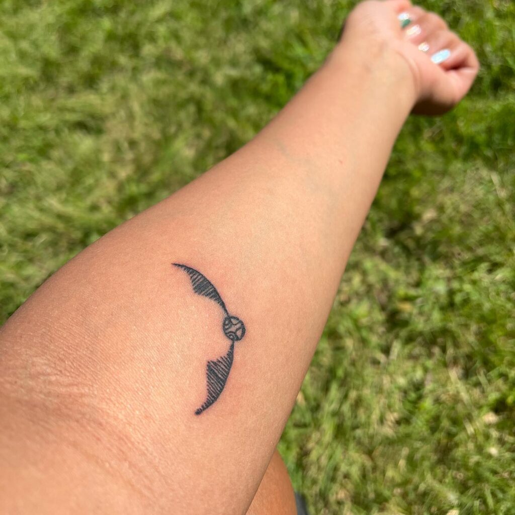 Whimsical Grace Hand Golden Snitch Tattoo for Girls image