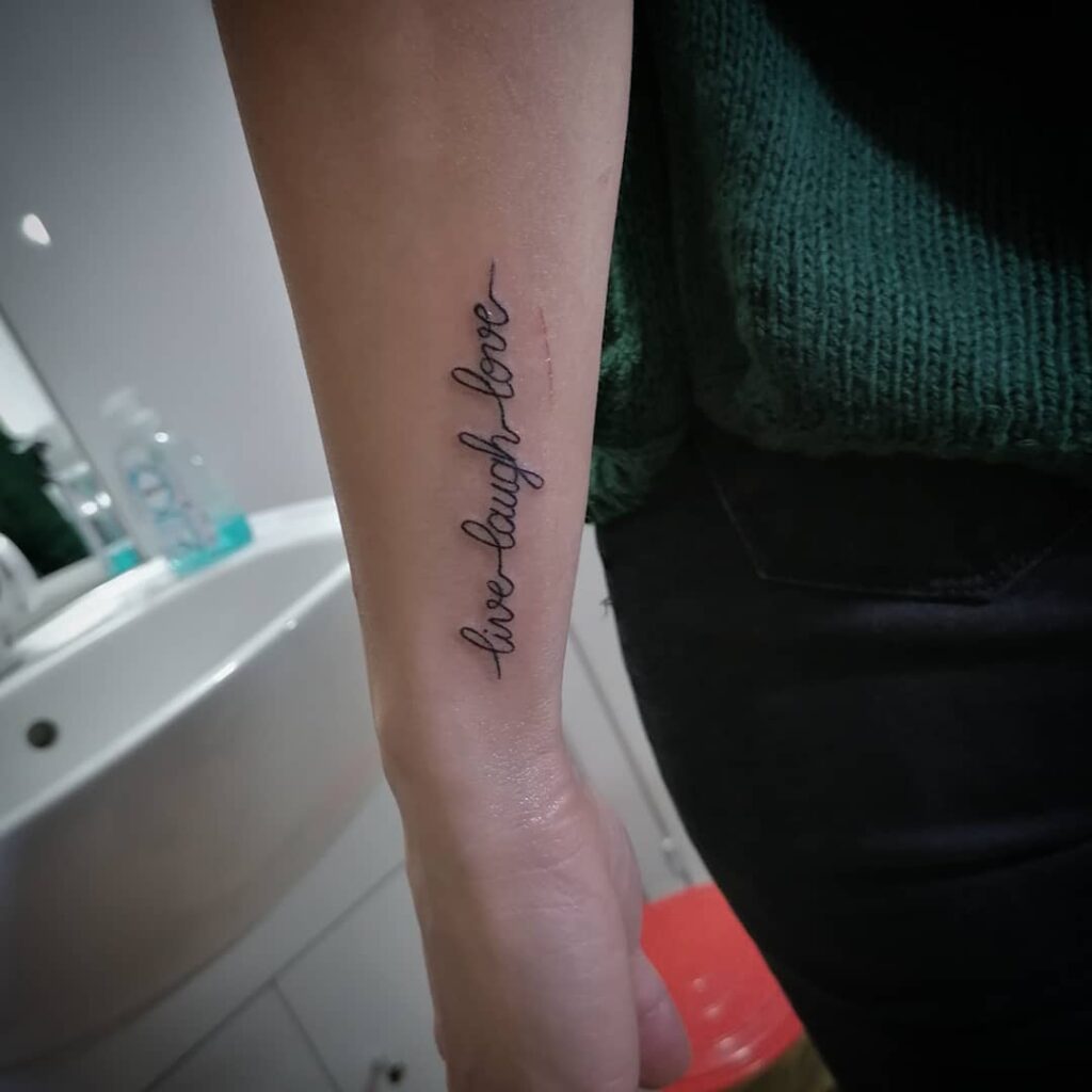 Whimsical Whispers Enchanting Cursive Forearm design