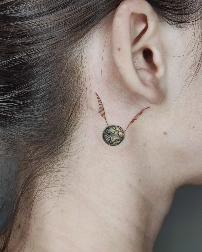 Whimsical Whispers Golden Snitch Behind Ear Tattoo for Women