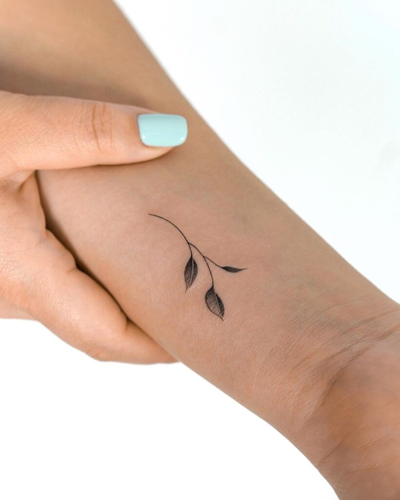 Whimsical leaves discover black and grey wrist tattoo design for nature lovers