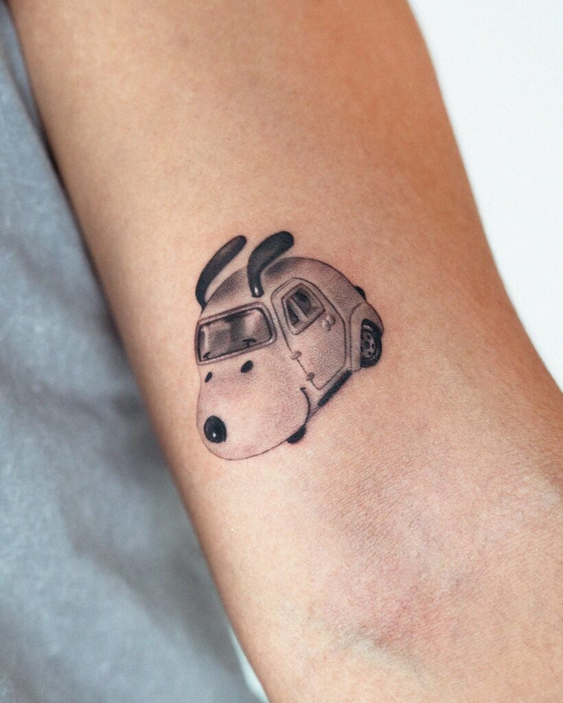 Whimsical Snoopy Car Tattoo with Playful Design and Shading on Forearm – Car Tattoo Ideas