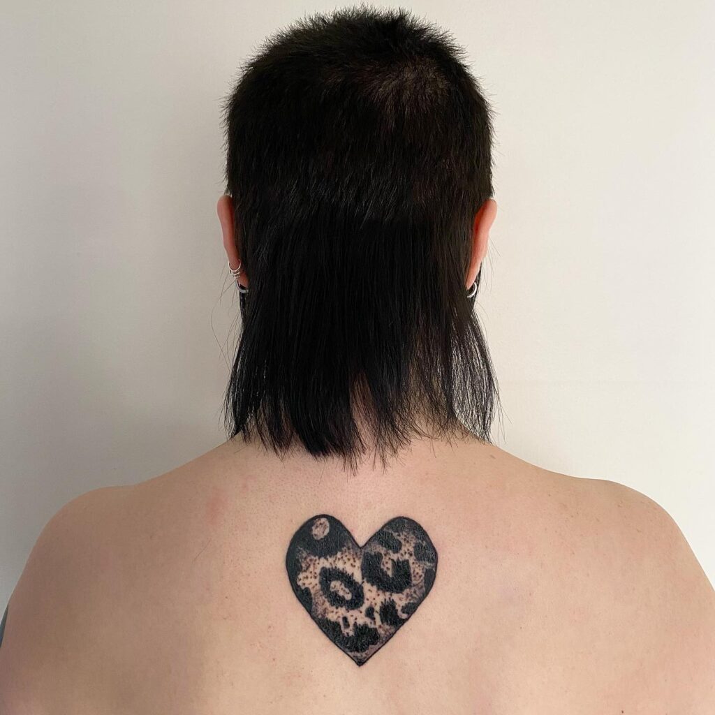 Wild at heart leopard with heart-shaped tattoo on the back of the neck