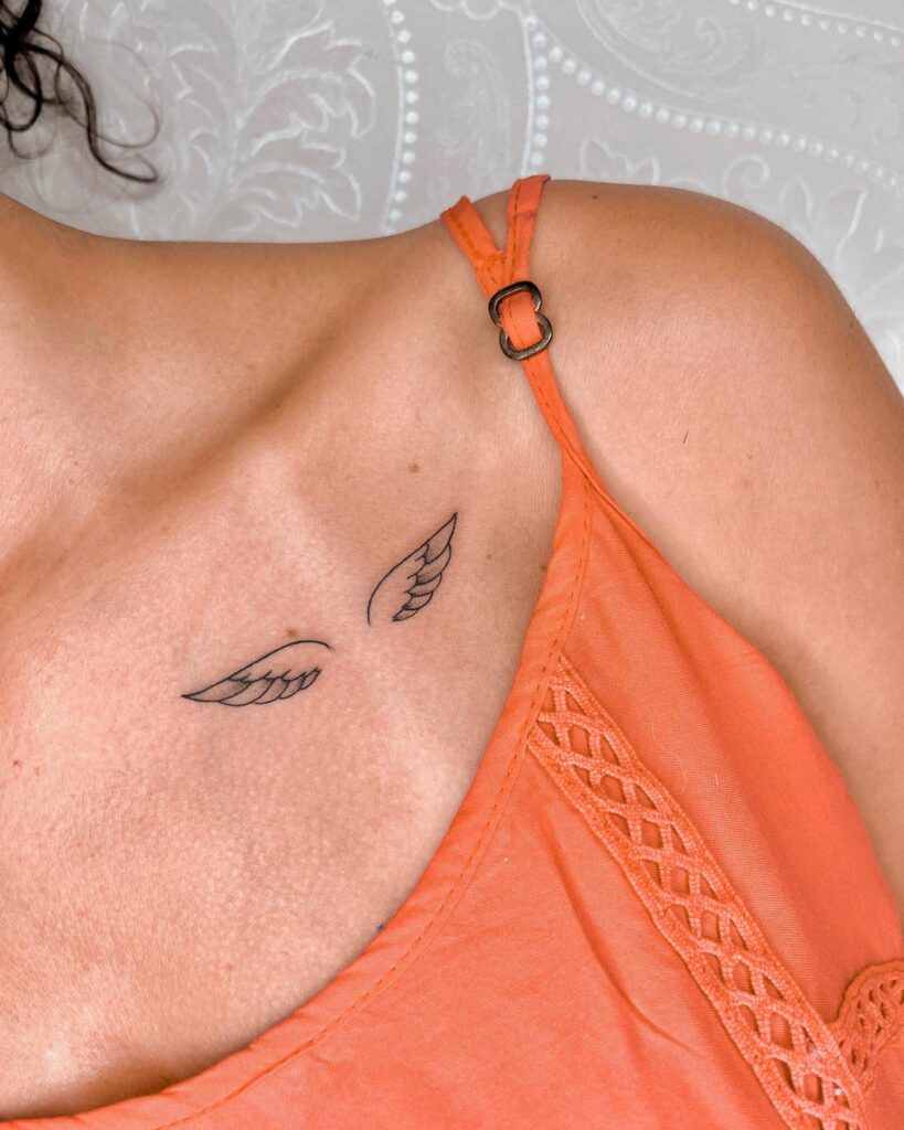Wing tattoo on the collarbone for females, small and uniquely stylish: winged whispers