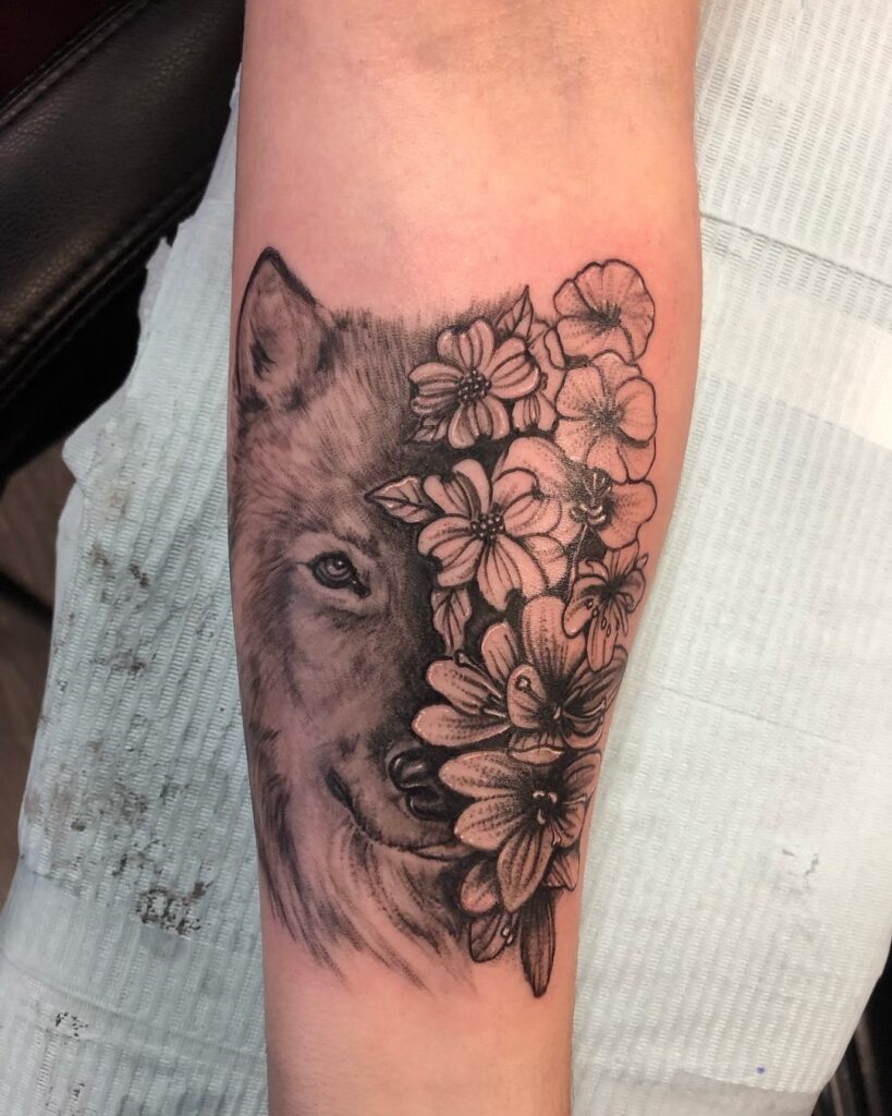 Wolf and flower forearm tattoo