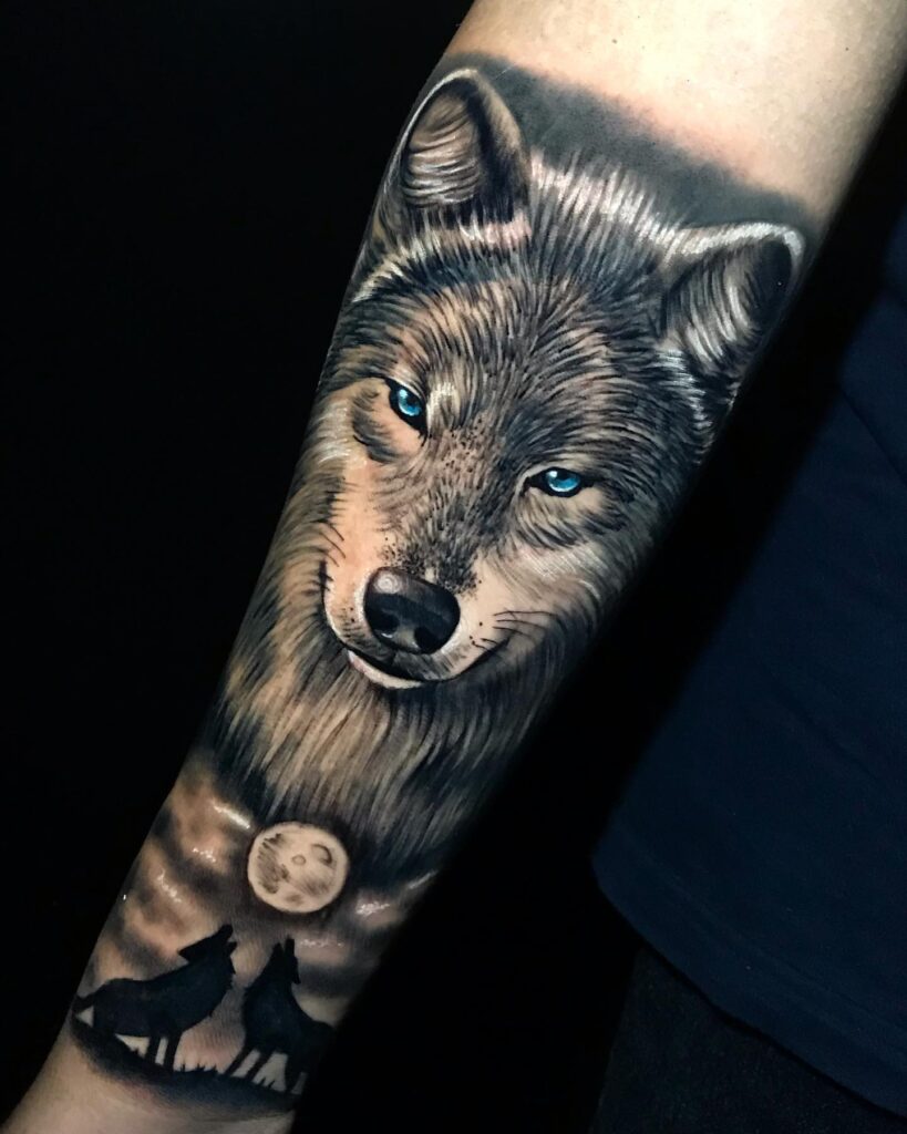 Wolf howling at the moon forearm tattoo