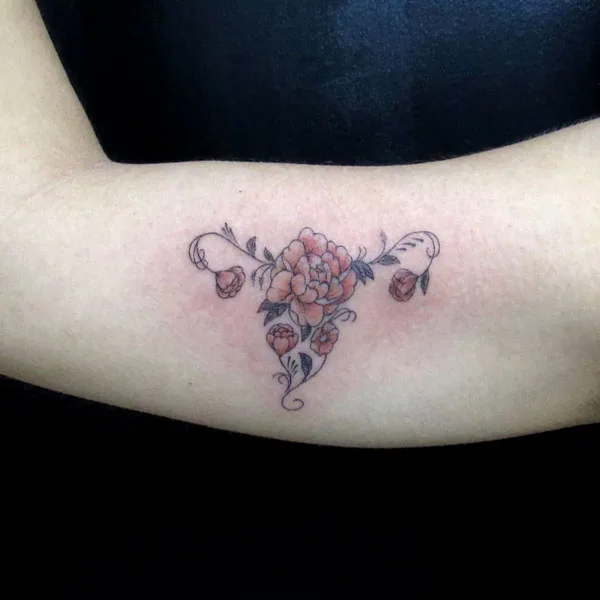 Womb tattoo on bicep