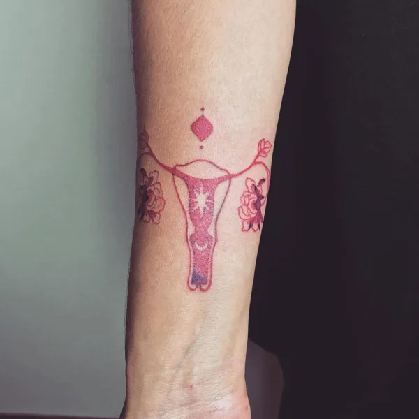 Womb tattoo on forearm