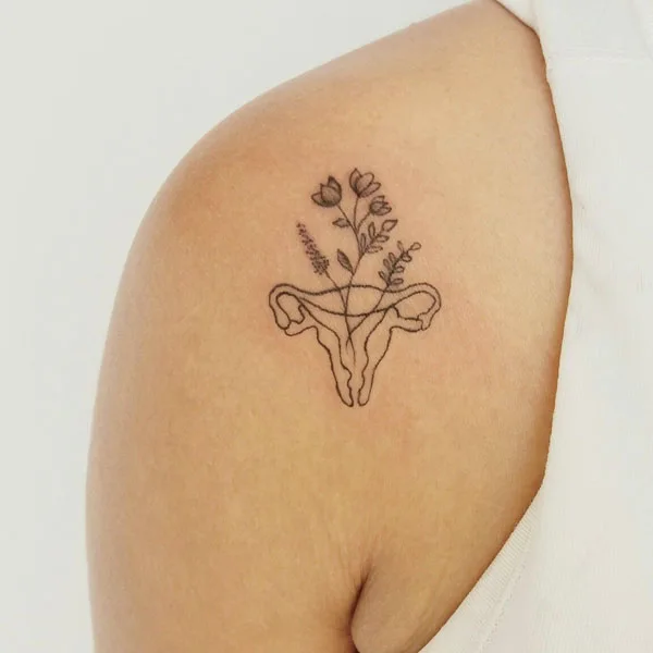 Womb tattoo on shoulder