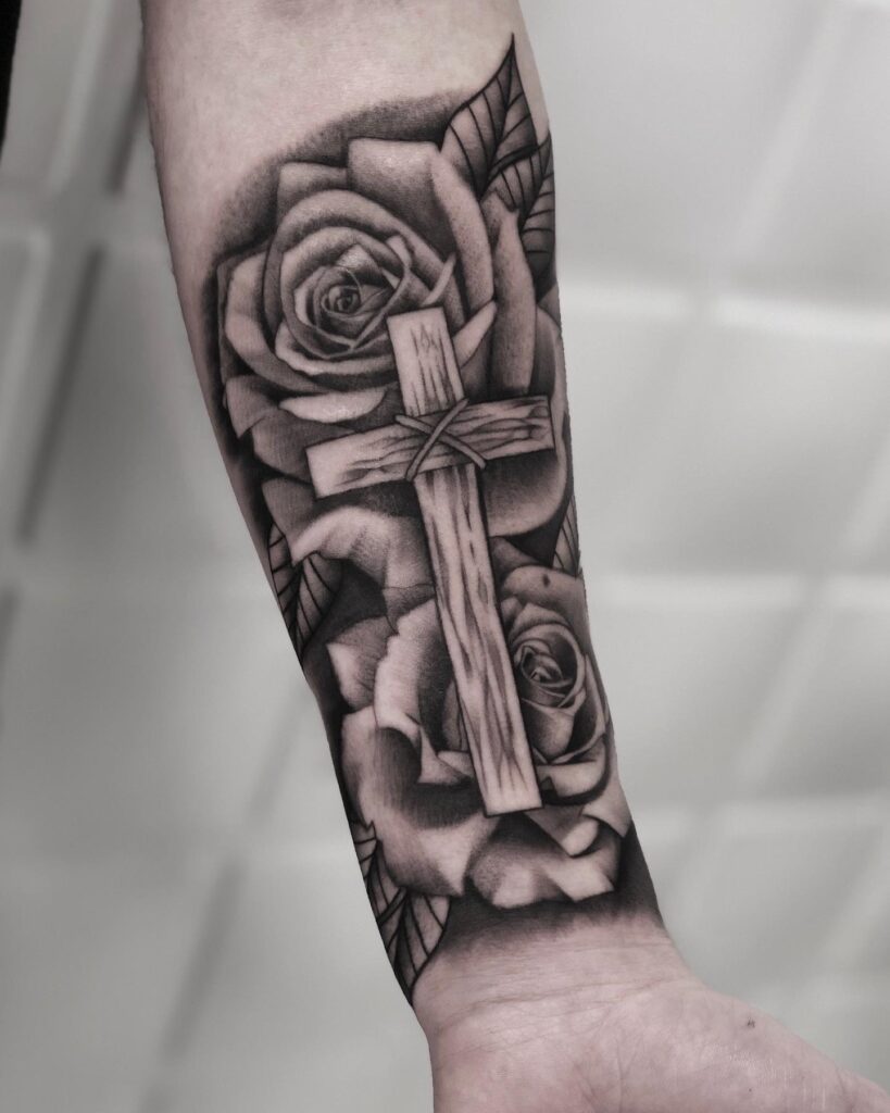 Wooden cross with roses by ink on forearm tattoo a natural elegance
