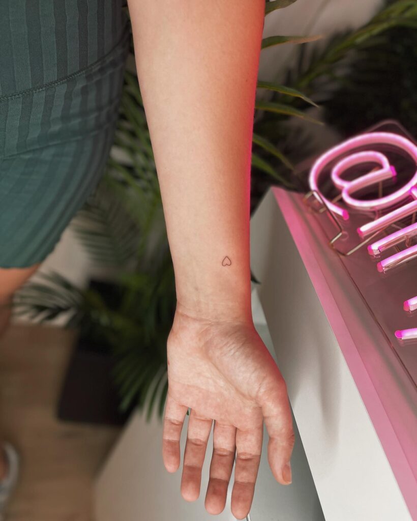 Wrist of love tiny heart outline tattoo for her