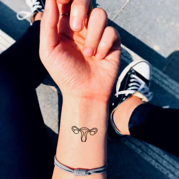 Wrist womb tattoo