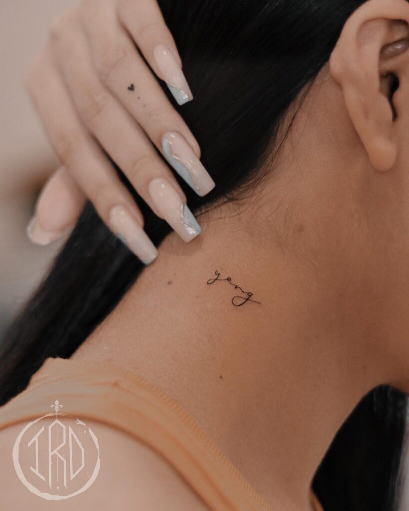 'yang' script word tattoo on the side of the neck, a minimalist art yin and yang essence