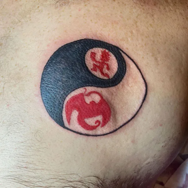 Yin-yang hatchet man tattoo