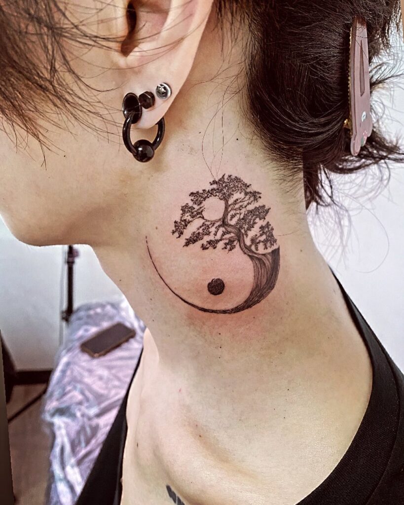 Yin yang tree tattoo on the side of the neck with deep meaning