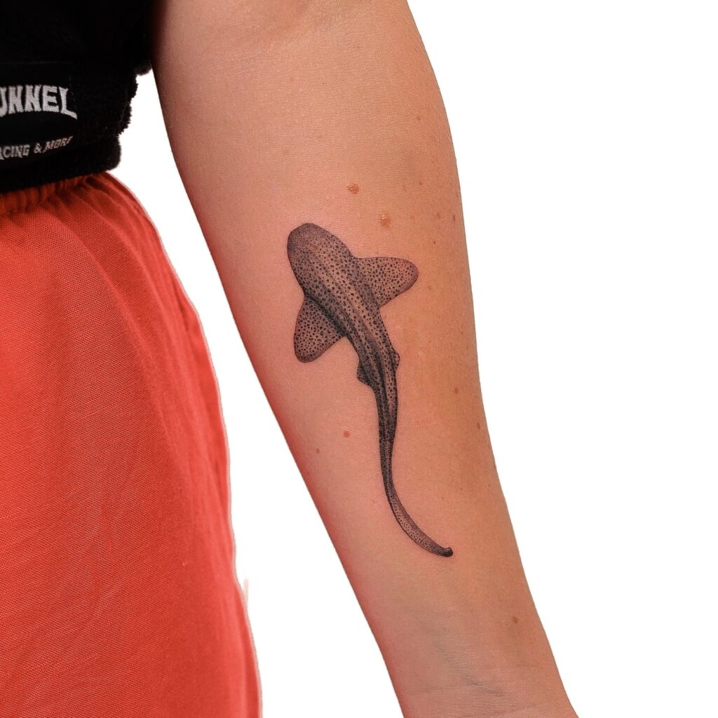 Zebra shark forearm tattoo with delicate dot shading, creating a natural flow and elegant appearance