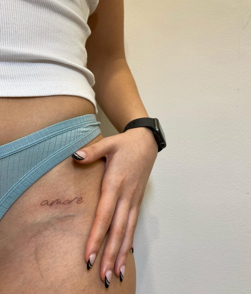 'Amore' Text Lettering Fineline Tattoo on the Hip: Romantic Notions