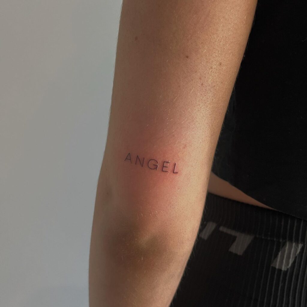 'Angel' Text Lettering on the Back of the Elbow: Angelic Grace