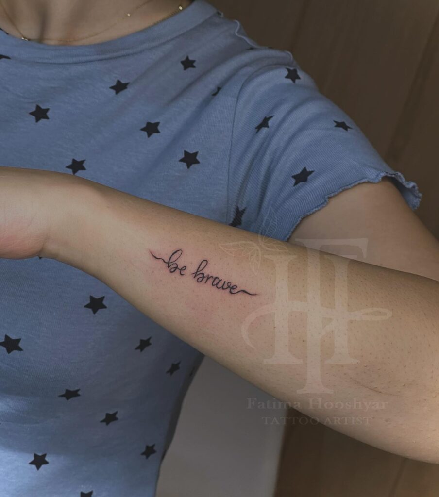 'Be Brave' Stylish Script Lettering Tattoo on the Side of the Forearm: Bold Encouragement