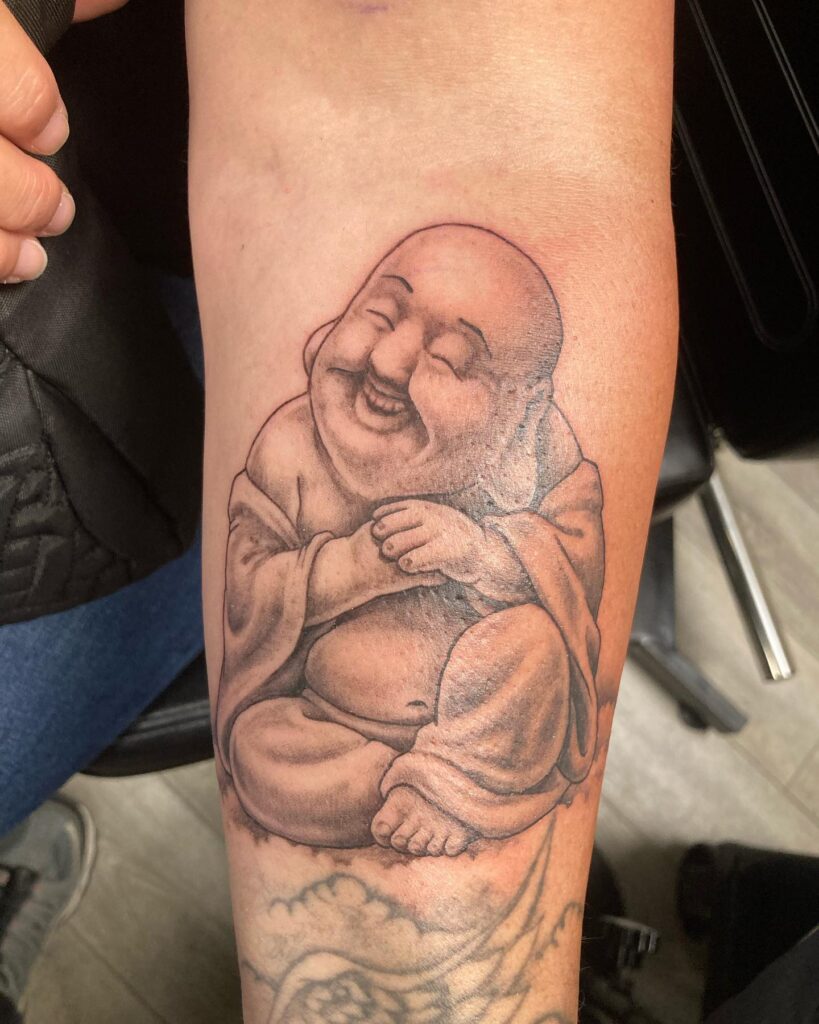 below the elbow laughing buddha tattoo for female subtle elegance 