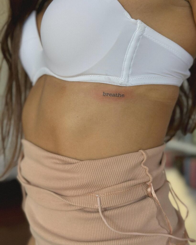 'Breathe' Word Lettering Tattoo for Females: Rib Serenity