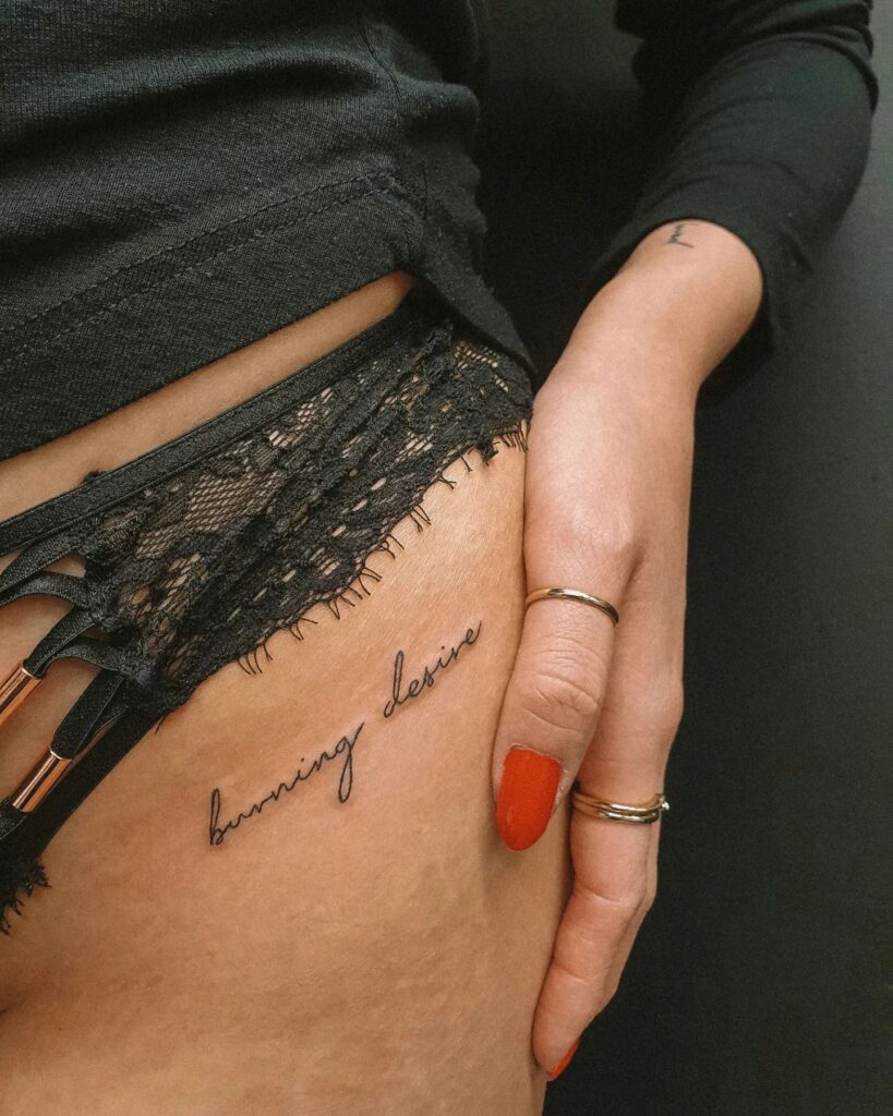 'Burning Desire' Text Script Lettering Tattoo on the Hip: Passionate Flames, an Embrace of Intensity