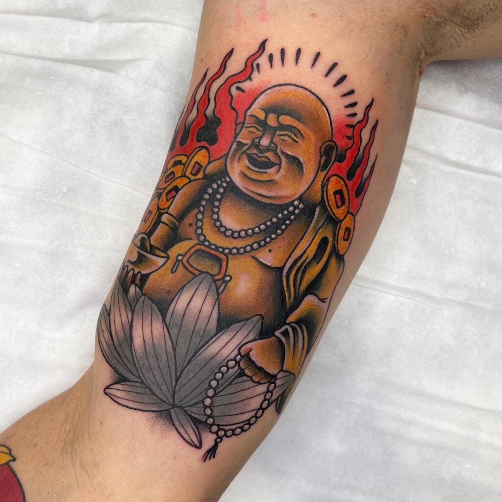 colorful traditional bicep laughing buddha tattoo for men vibrant symbolism 